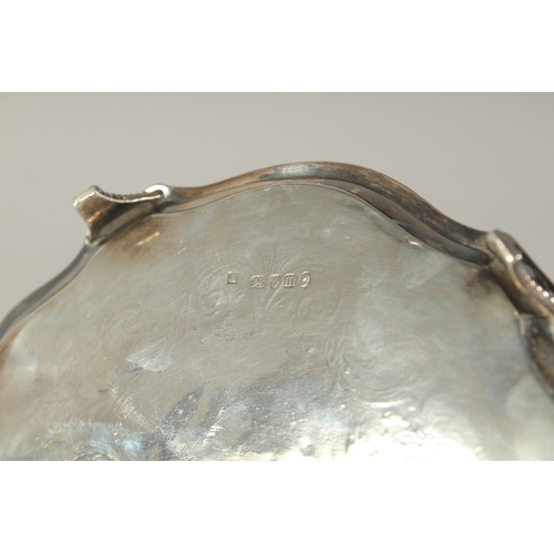 1711 - A GOOD GEORGE III SILVER OVAL TEA POT STAND with engraved decoration and crest, on four curving legs... 