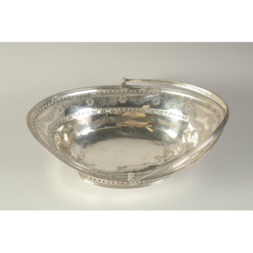 1756 - A LARGE GEORGE III SILVER OVAL CAKE BASKET with swing handles engraved with garlands. 13ins long. Lo... 