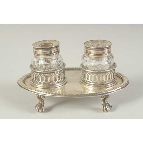 1763 - A GOOD EARLY GEORGE III TWO BOTTLED INKSTAND with pierced bottle holders, supported on four claw and... 