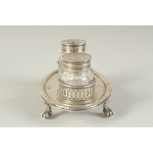 1763 - A GOOD EARLY GEORGE III TWO BOTTLED INKSTAND with pierced bottle holders, supported on four claw and... 