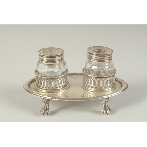 1763 - A GOOD EARLY GEORGE III TWO BOTTLED INKSTAND with pierced bottle holders, supported on four claw and... 