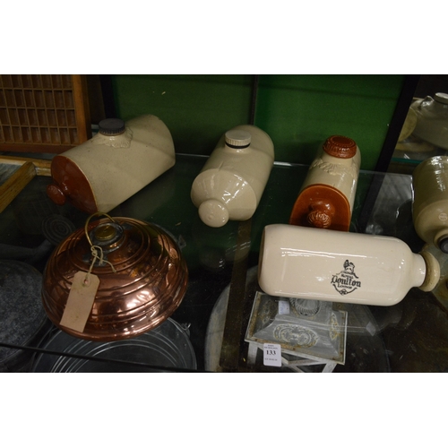 133 - Collection of old stone hot water bottles and other bygones to include a wash board.