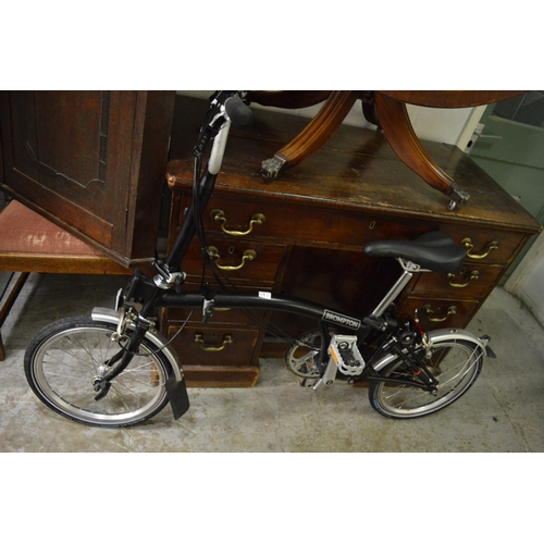 149 - A good Brompton black painted folding bicycle.