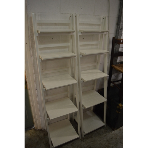 151 - A pair of white painted folding five tier display shelves.