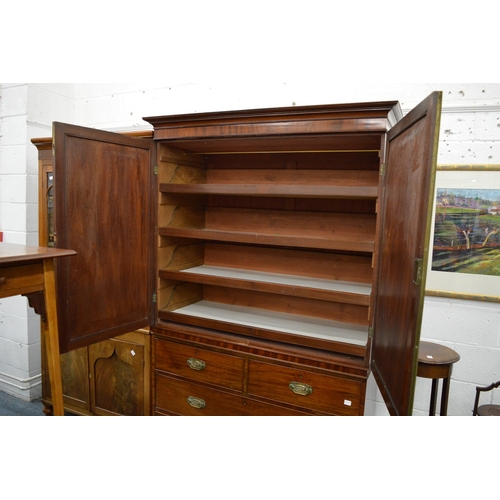 179 - A George III mahogany linen press with pair of panel doors enclosing four sliding trays above a base... 