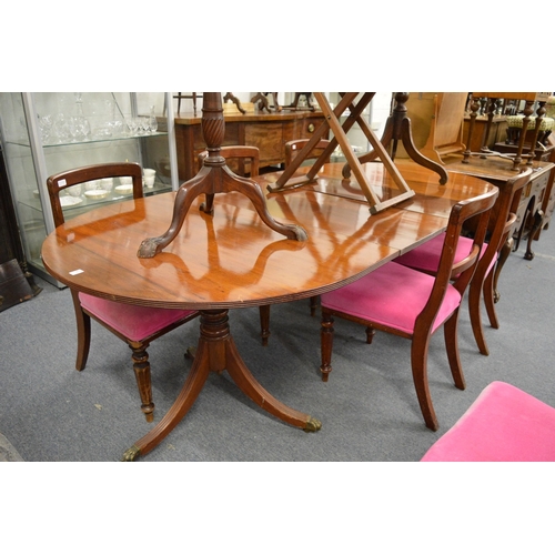 193 - A 19th century mahogany twin pillar dining table with two leaves.