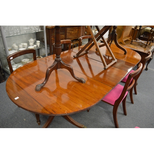 193 - A 19th century mahogany twin pillar dining table with two leaves.