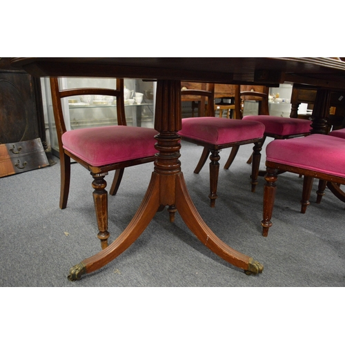 193 - A 19th century mahogany twin pillar dining table with two leaves.