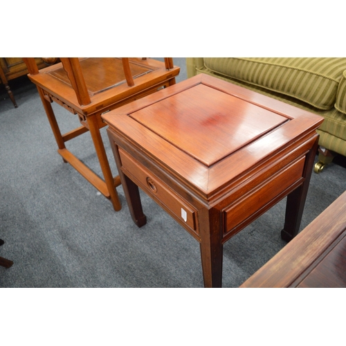 215 - A pair of Chinese red wood single drawer lamp tables.