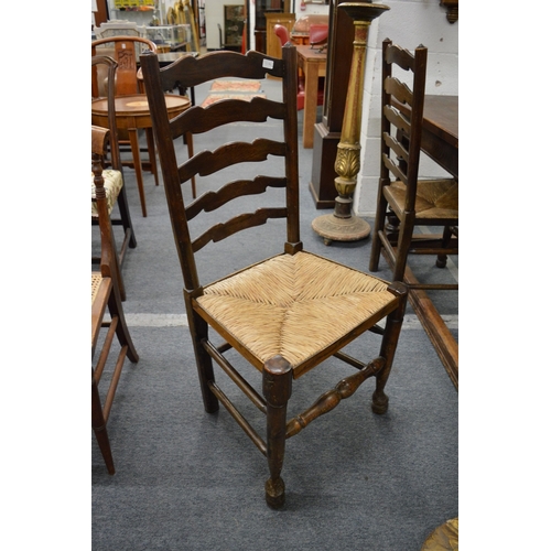 237 - A rush seated ladder back carver chair and three side chairs.