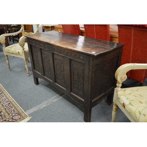 248 - A 17th century oak coffer with carved frieze and panels.