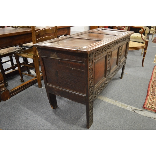 251 - A 17th century oak coffer with triple panelled rising top above a triple panelled front with carved ... 