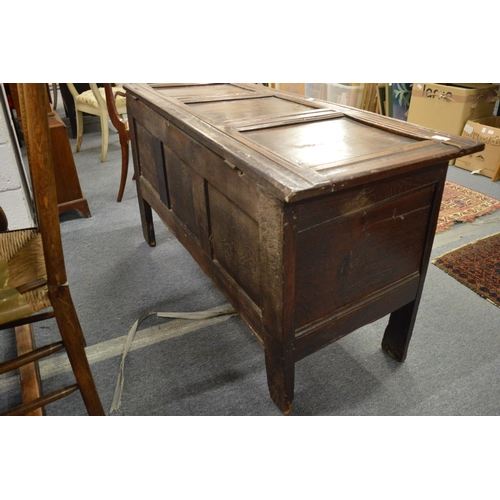 251 - A 17th century oak coffer with triple panelled rising top above a triple panelled front with carved ... 