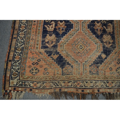 259 - A small Persian rug (moth damage and worn) 115cm x 87cm.