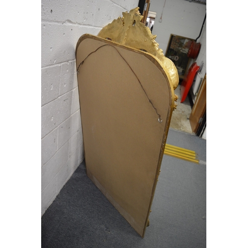 265 - A large decorative mirror with shaped cresting.