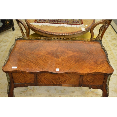 278 - A 19th century rosewood Poudreuse style table, of shaped outline with brass galleried back, three de... 