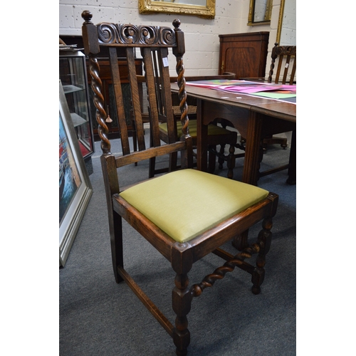 290 - An oak drop-leaf gateleg dining table and four oak dining chairs.