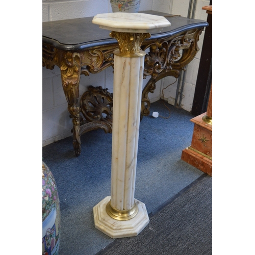 309 - A good pair of cream marble columns with octagonal tops and bases.