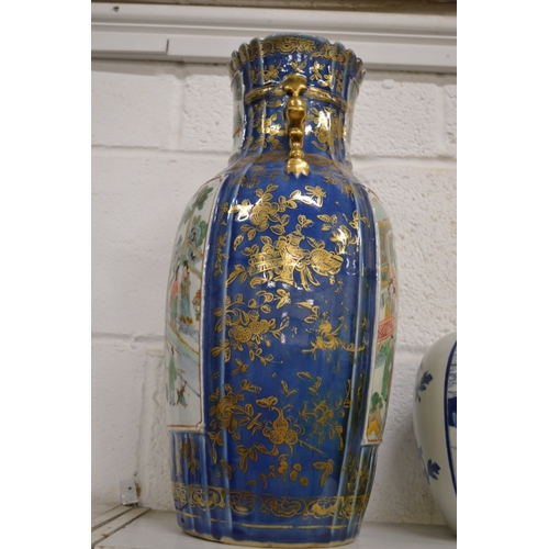 434 - A large Chinese vase, blue ground with gilded decoration painted with panels of figures in a courtya... 