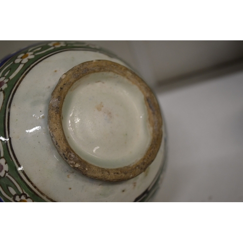 449 - An Islamic Persian Kashgar pottery bowl painted with three panels depicting busts of gentleman.