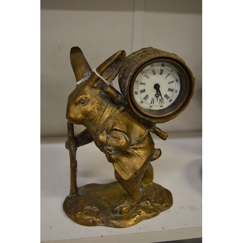 461 - A novelty brass mantel clock modelled as a rabbit carrying some firewood on his back.