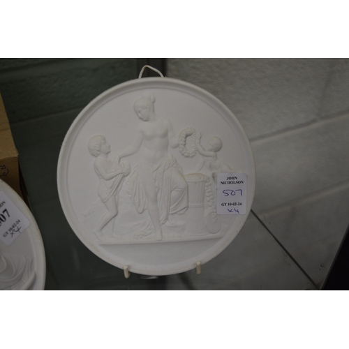 507 - A set of four Copenhagen circular white biscuit porcelain plaques.