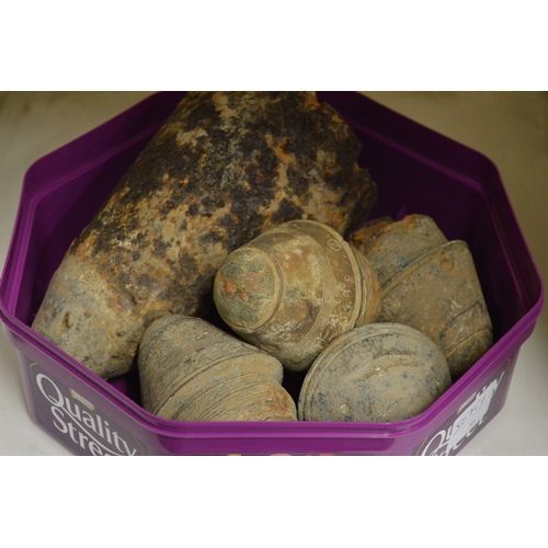 54 - A group of excavated ammunition shell heads.