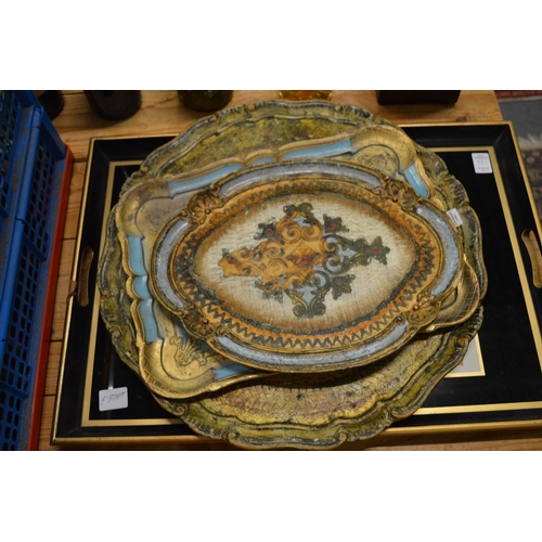 551 - An ormolu twin branch wall light, decorative trays and a mirror.