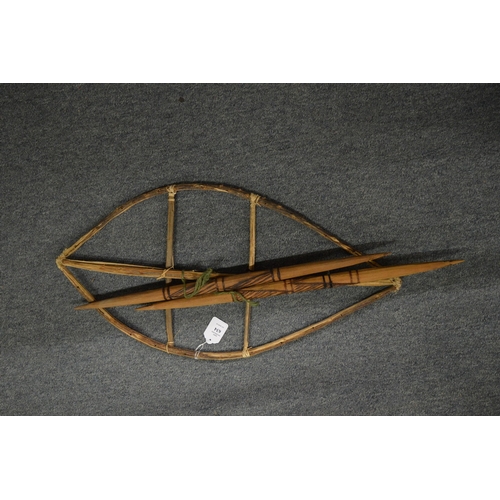 634 - A shield frame and carved wood spears.