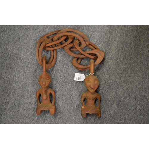 635 - An unusual carved wood chain with figural ends.