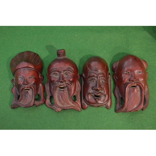 754 - Four small Japanese carved wood masks.