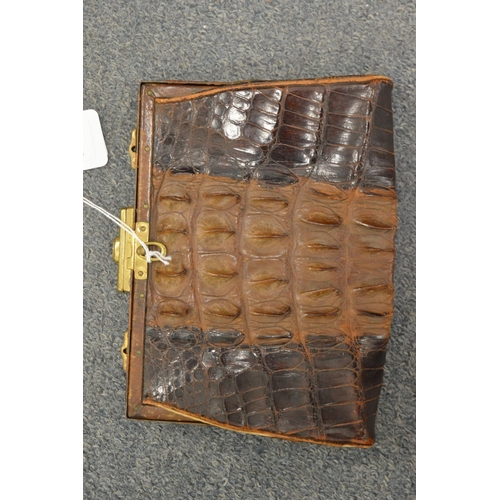 828 - An alligator clutch bag.