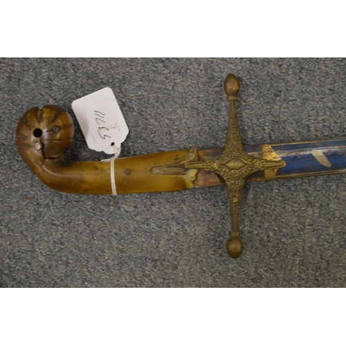 833 - A Scimitar with horn handle, etched and blued steel blade with leather covered scabbard and brass mo... 