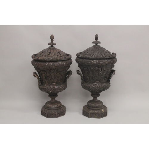 1005 - A GOOD LARGE PAIR OF URNS AND COVERS, POSSIBLY IRISH, carved with cupids and scrolls, with pineapple... 