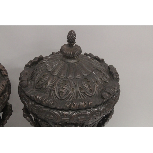 1005 - A GOOD LARGE PAIR OF URNS AND COVERS, POSSIBLY IRISH, carved with cupids and scrolls, with pineapple... 