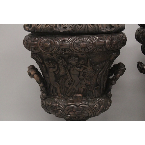 1005 - A GOOD LARGE PAIR OF URNS AND COVERS, POSSIBLY IRISH, carved with cupids and scrolls, with pineapple... 