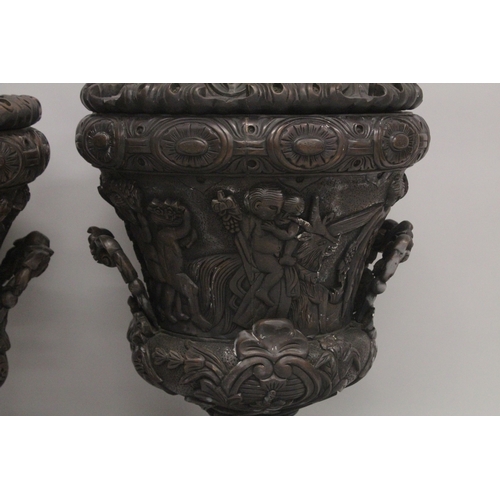 1005 - A GOOD LARGE PAIR OF URNS AND COVERS, POSSIBLY IRISH, carved with cupids and scrolls, with pineapple... 