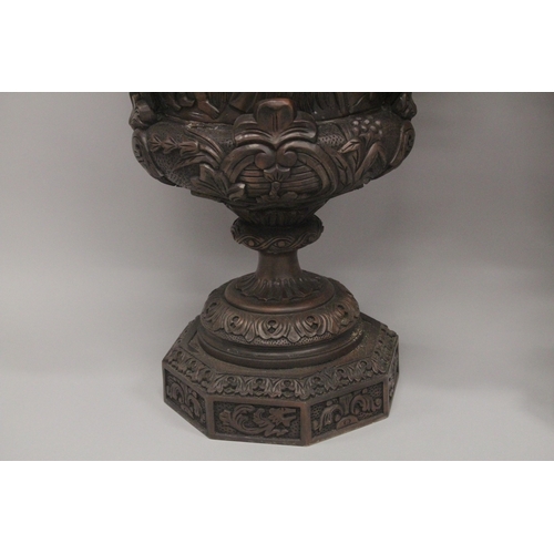 1005 - A GOOD LARGE PAIR OF URNS AND COVERS, POSSIBLY IRISH, carved with cupids and scrolls, with pineapple... 