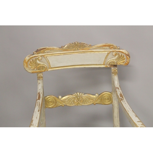 1034D - A PAIR OF CARVED, PAINTED AND PARCEL GILDED OPEN ARMCHAIRS, with floral upholstered overstuffed seat... 