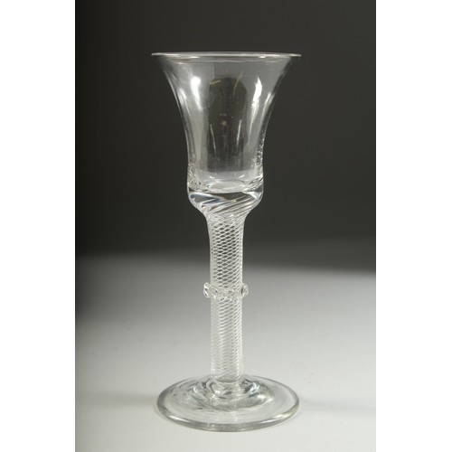 1036 - A GEORGIAN WINE GLASS with inverted bell bowl, knop stem with air twist. 7ins high.