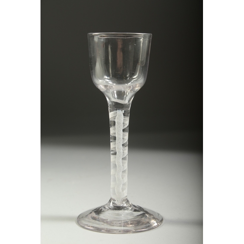 1037 - A GEORGIAN WINE GLASS with white air twist stem. 5.5ins high.