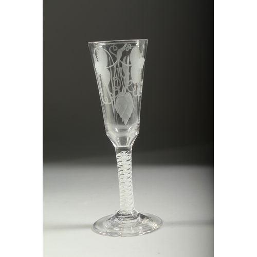 1038 - A GEORGIAN WINE GLASS with white air twist stem, long flute engraved with hops. 7ins high.