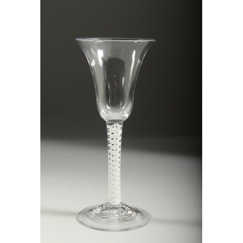 1039 - A GEORGIAN WINE GLASS with inverted bell bowl and white twist stem. 7ins high.