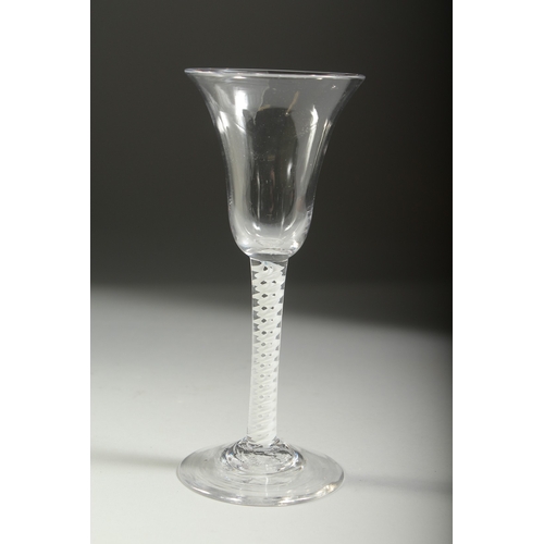 1039 - A GEORGIAN WINE GLASS with inverted bell bowl and white twist stem. 7ins high.