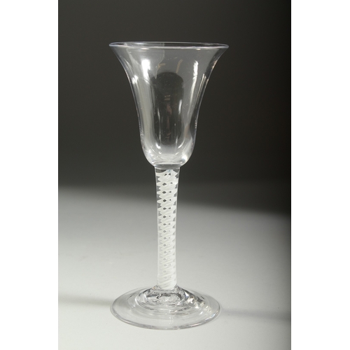 1039 - A GEORGIAN WINE GLASS with inverted bell bowl and white twist stem. 7ins high.