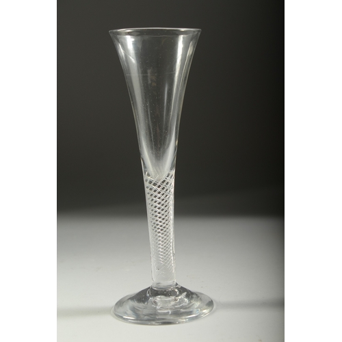 1041 - A GEORGIAN WINE GLASS with long, plain tapering bowl and air twist stem. 7.25ins high.