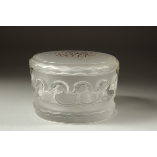 1050 - A LALIQUE FROSTED GLASS CIRCULAR POWDER BOWL AND COVER the lid with gilt calligraphy. Signed, Laliqu... 