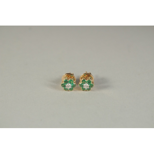 1780 - A PAIR OF 18CT YELLOW GOLD, DIAMOND AND EMERALD FLOWER HEAD EAR STUDS.