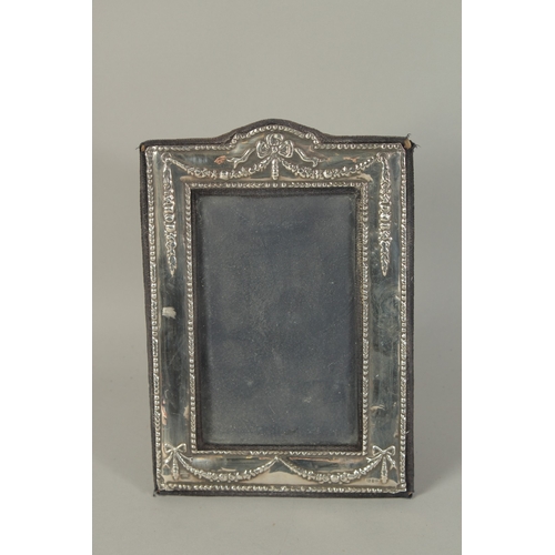 1861 - A SILVER PHOTOGRAPH FRAME with ribbons motif. 7.5ins x 5.5ins.  London 1968.