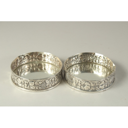 1863 - A PAIR OF .800 SILVER FRUITING VINE COASTERS. 4.5ins diameter.